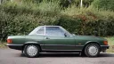 Right side of a green 1989 Mercedes-Benz 420 SL with a fitted hardtop and silver alloy wheels