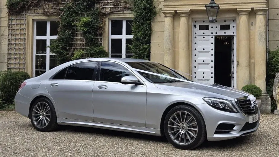 Silver Mercedes S 350 LWB parked outside a stone-built wedding venue