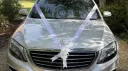 Silver Mercedes S-Class bonnet decorated with white wedding ribbons and bows