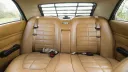 Cream rear bench seat with seat belts inside a Ford Cortina Mk4