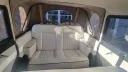Cream upholstered rear bench and enclosed passenger cabin inside a Badsworth Landaulette