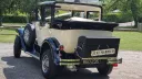Rear three-quarter view of a Badsworth Landaulette with its rear roof open and Just Married sign