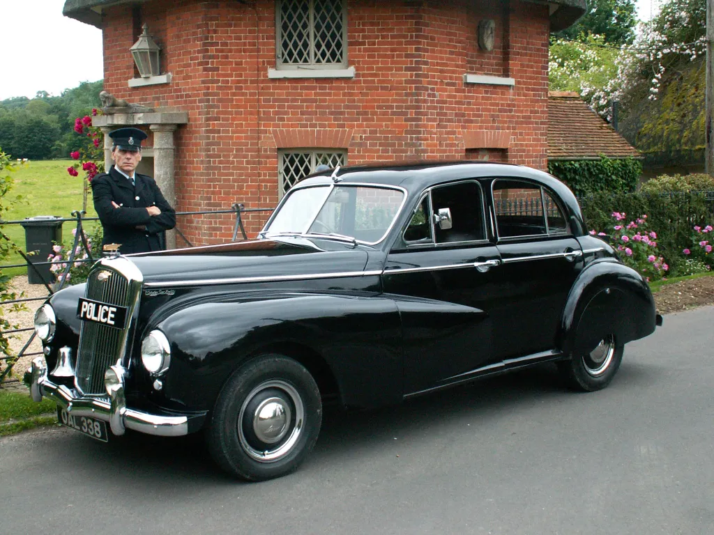 Black Wolseley Police Car with Chauffeur in Period Police uniform standing by the vehicle
