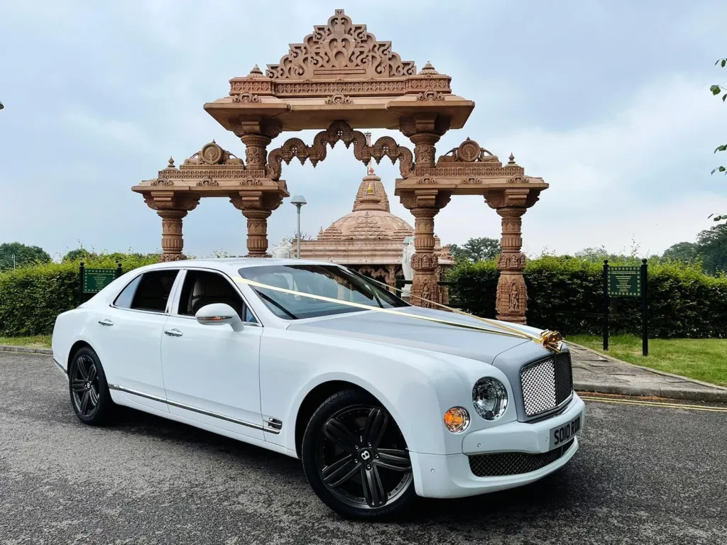 white Bentley Mulsanne with Silver Bonnet parked outside a popular Asian temple in London