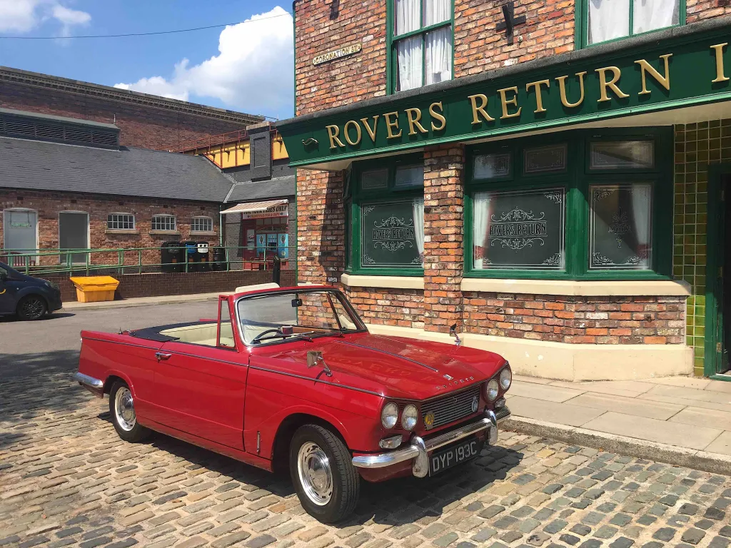Red Triumph Convertible in front of the Rovers Pub in Coronation Street