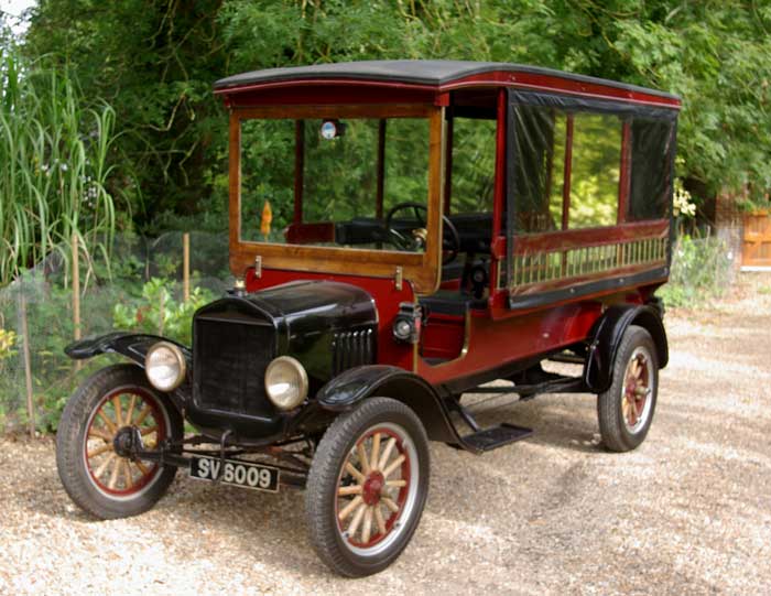 Burgundy vintage Ford Charabanc with wooden spoke wheels