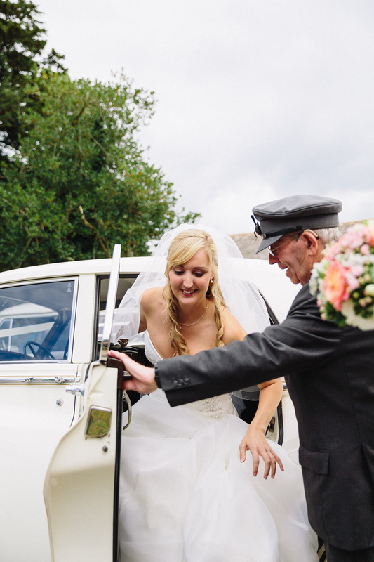 Chauffeur holding the door for the bride