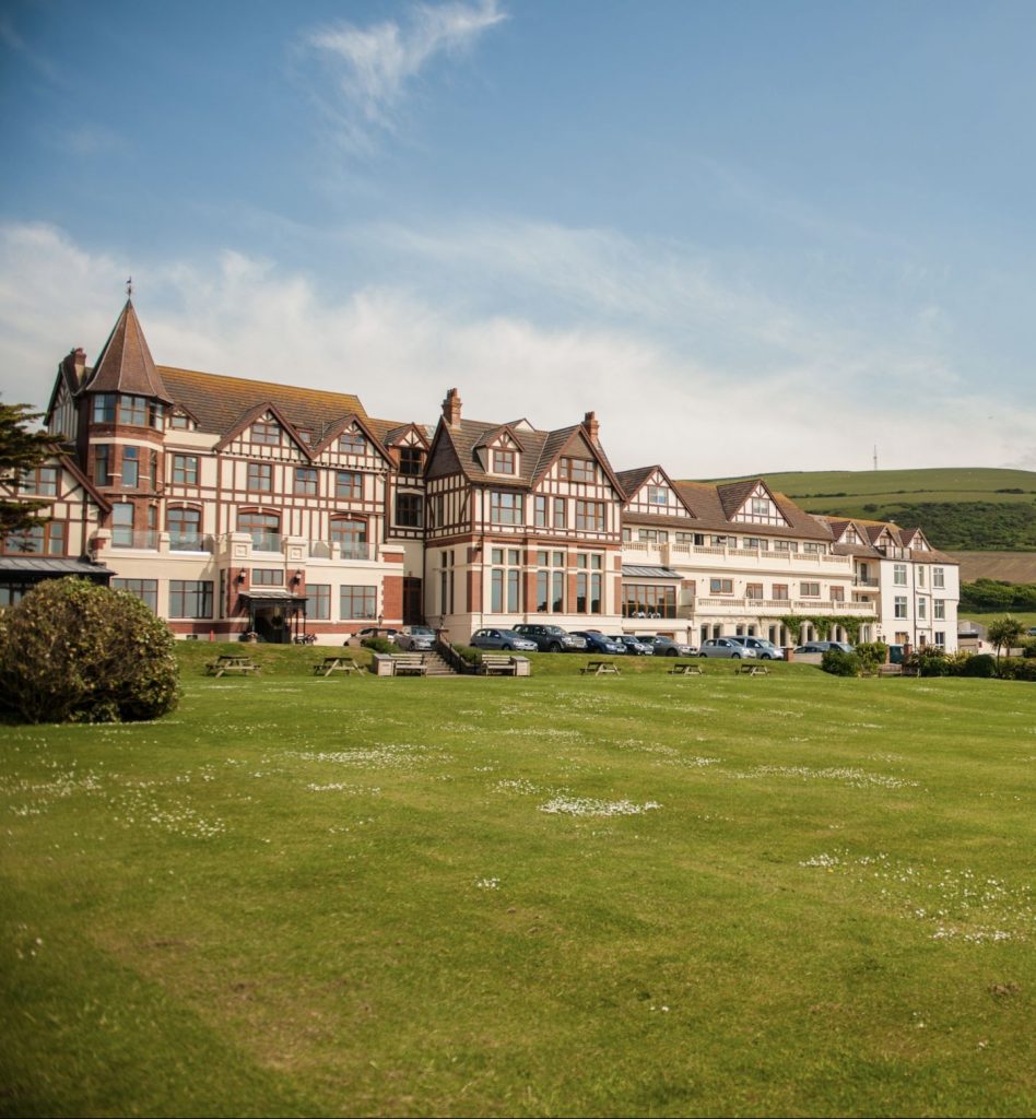 Front view of the Woolacombe Bay Hotel showing manor house with wood beam accros the wall and window frame