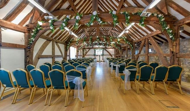 Cermeony Room at Westgate Hall with Turquoise blue chairs. wooden high beams, vaulted ceiling and flower decoration around the wooden beams