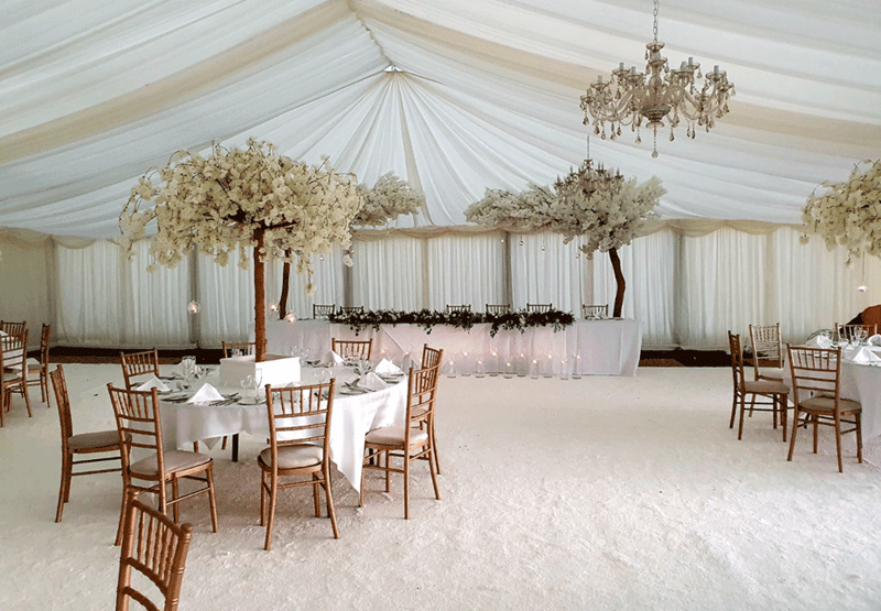 Tong Park Hotel Reception room in a White Marquee with white tree decoration and chandelier