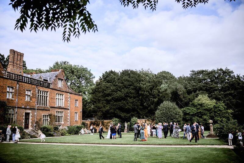Rear garden of the wedding venue with wedding guests 