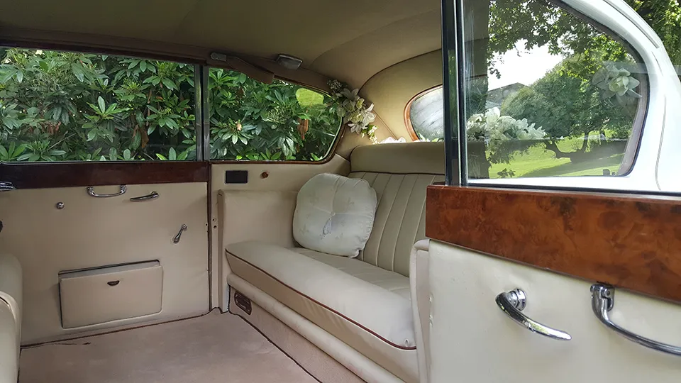Cream leather interior with casual seats down showing a very large rear cabin inside a classic Austin Princess Limousine