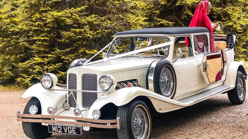 Rear view of classic 7-saeater Austin Princess Limousine with Bride and Groom parked in street of London by the Old Marylebone Town Hall