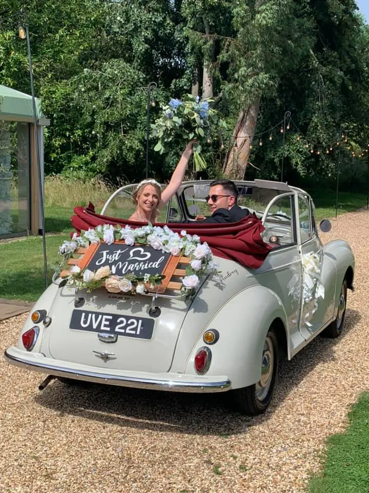 Classic wedding car decorated with flowers and a Just Married sign