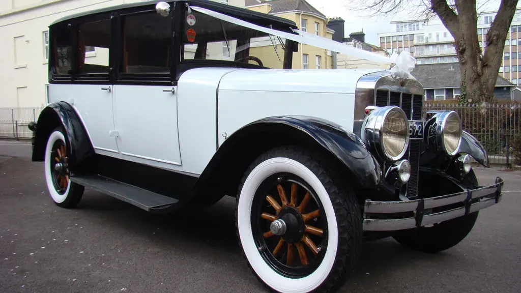 Black & Ivory vintage Franklin Car with white ribbons, white wall tires and wooden spoked wheels