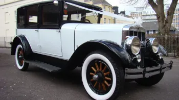 Black & Ivory vintage Franklin Car with white ribbons, white wall tires and wooden spoked wheels