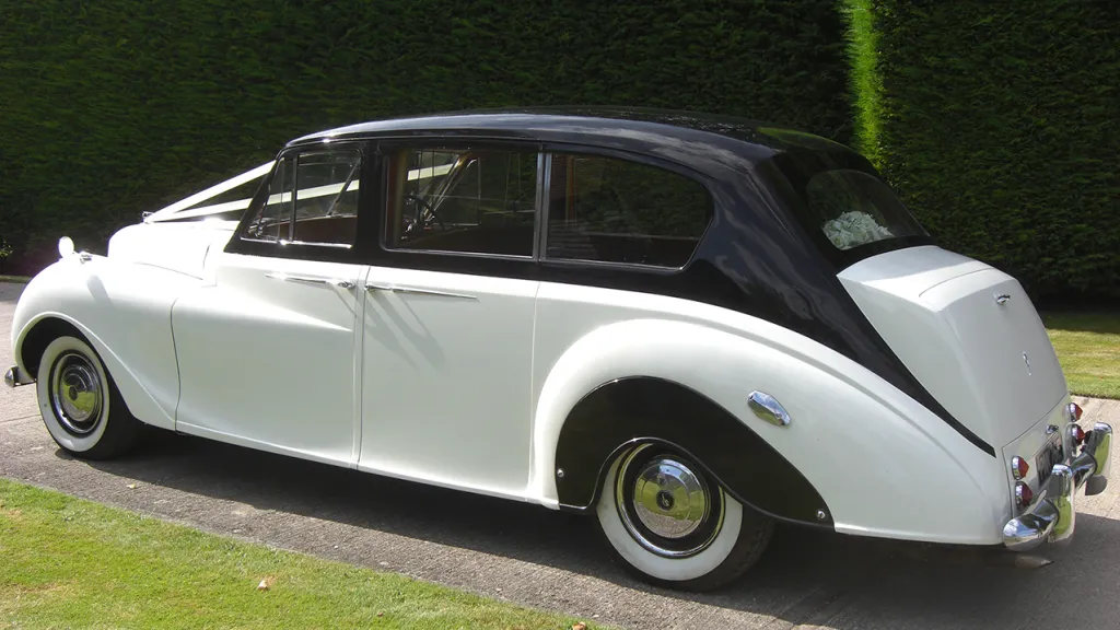 Left Side View of Austin Princess Limousine shwoign the black roof over white colour.