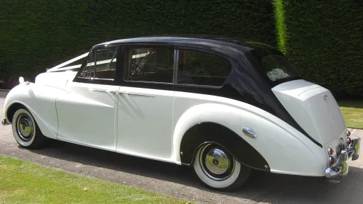 Left Side View of Austin Princess Limousine shwoign the black roof over white colour.