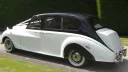 Left Side View of Austin Princess Limousine shwoign the black roof over white colour.