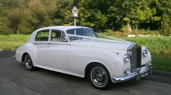Rolls-Royce Silver Cloud 3/4 view with forest background