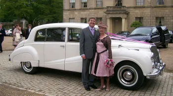 groom and mother taking photos in front of the car near the cermeony venue in uxbridge