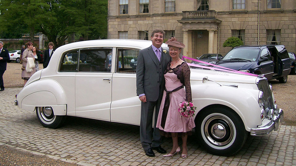 groom and mother taking photos in front of the car near the cermeony venue in uxbridge
