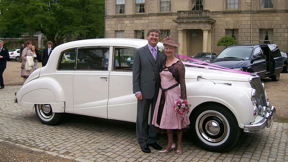 groom and mother taking photos in front of the car near the cermeony venue in uxbridge