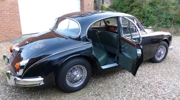 Side view of Black Jaguar with Rear passengers door open showing Green Leather inside the vehicle