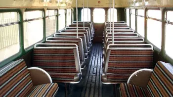 interior seating in Single Decker Bus showing the check cloth seats