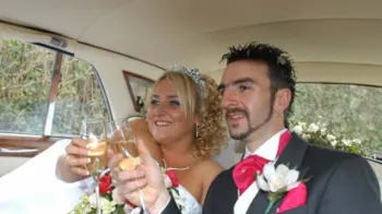 Bride and Groom having a celebration champagne toast inside Rolls-Royce