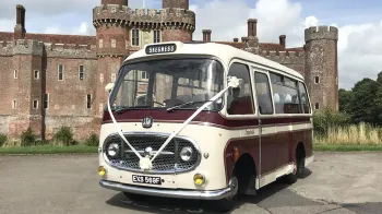 Single decker bedford bus in Cream and Burgundy dressed with white wedding ribbons and bows