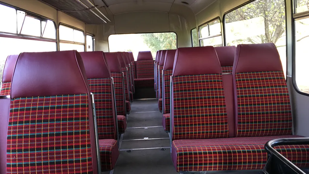single decker bus interior with Burgundy checker seats