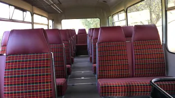 single decker bus interior with Burgundy checker seats