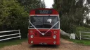 Full front view of a classic red single decker bus
