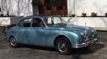 Blue Daimler 250 V8 with chrome spoke wheels withour wedding decoration