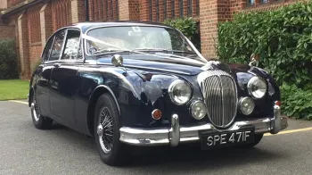 Dark Blue Classic Daimler 250 V8 with white ribbons