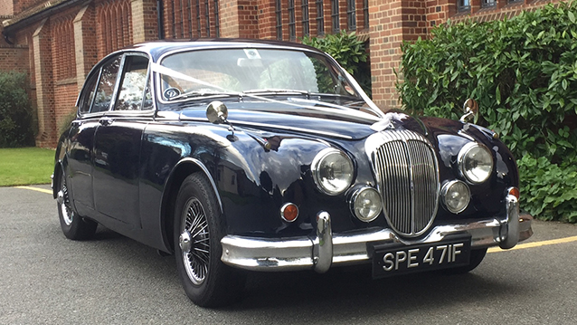 Dark Blue Classic Daimler 250 V8 with white ribbons