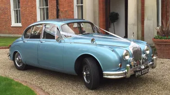 Right Side of Electric Blue Daimler 250 V8 decoratyed with white ribbons and bows