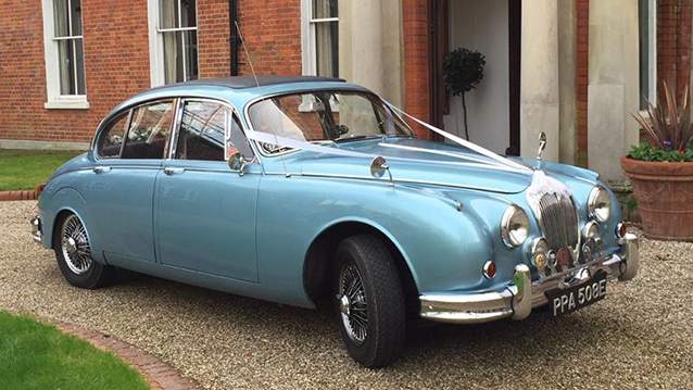Right Side of Electric Blue Daimler 250 V8 decoratyed with white ribbons and bows