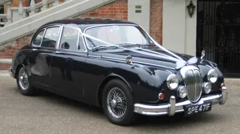 Front side view os classic Daimler 250 V8 with white ribbons