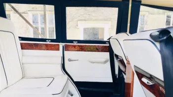 rear interior space inside Beauford with white leather interior