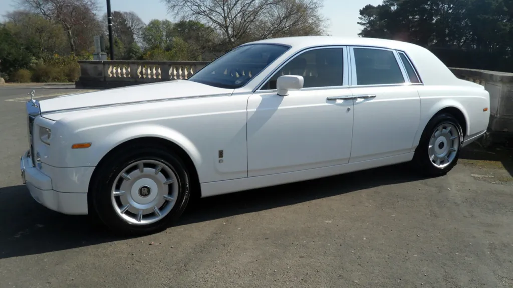 Left sode view of white Rolls-Royce Phantom with door closed