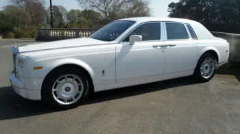 Left sode view of white Rolls-Royce Phantom with door closed