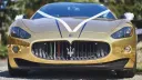 Full Front view of Maserati GranTurismo decorated with White ribbons and Trident logo in the middle of the grill