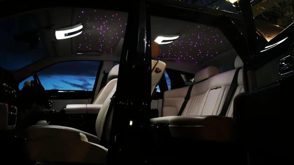 Rolls-Royce Phantom interior with both doors open and pink illuminated star light roof