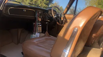 Front passenger seating area with large legroom and beige leather interior seat