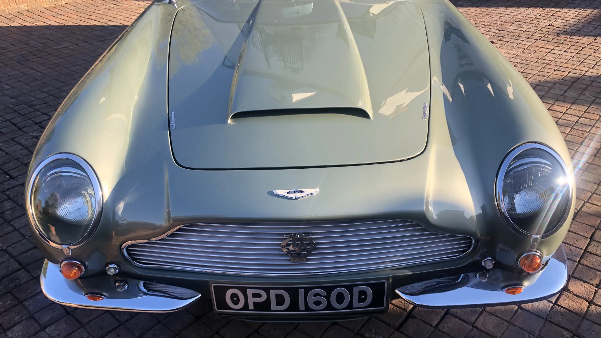 Front view of Aston Martin iconic front grill and badge on top