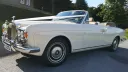 Left side view if Ivory Rolls-Royce Corniche Convertible with roof open
