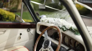 Front interior passenger with cream door cards, wooden steering wheel and dashboard