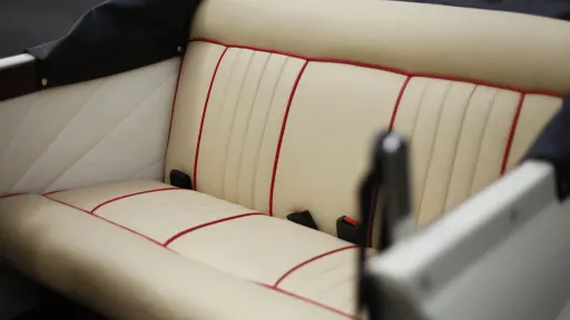 Cream leather rear seats with burgundy pipping.